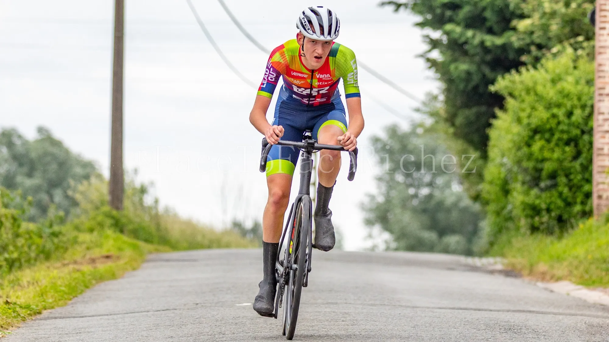 Xander riding hard up a quiet country road